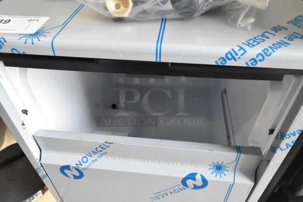 Brand new Scotsman UC0918GAX-1A undercounter ice machine, 95 lb capacity, minor scratches, protective film visible.