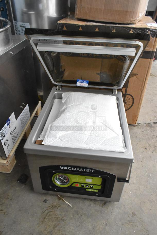 BRAND NEW VacMaster VP230 tabletop vacuum packaging machine with open lid. Includes 12 1/4" seal bar, 115 volts.