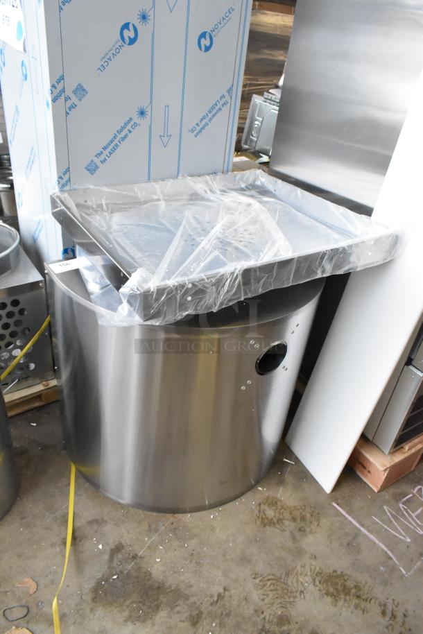 Brand new KoolMore receptacle, stainless steel, visibly wrapped, minor scratches and dents, protective packaging intact.