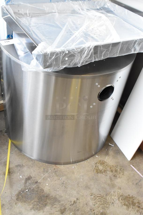 Brand new KoolMore receptacle with minor dents, stainless steel finish, and protective plastic wrap, indicating unused condition.