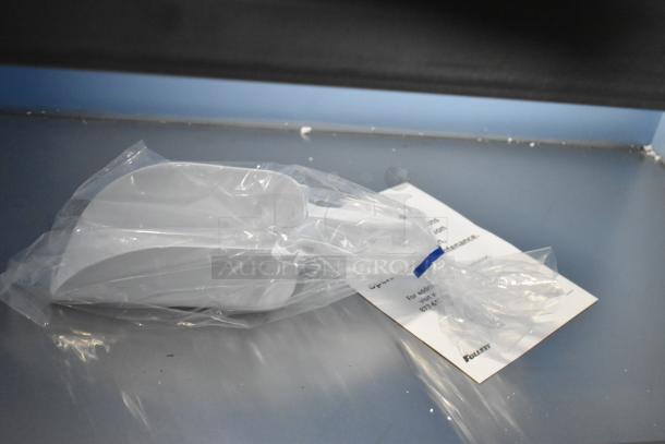 Plastic-wrapped component with Follett branding tag from new SG1650S-60 Ice Storage Bin, 1660 lb capacity.