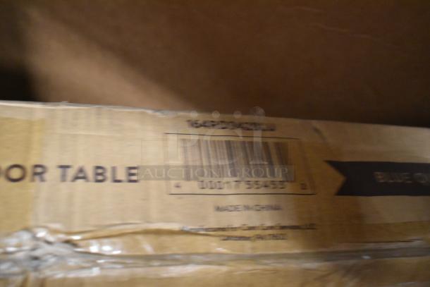Cardboard box showing part of a barcode, marked "Made in China." Box is for an indoor table, part of a scratch and dent auction.