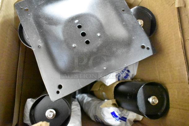 Box containing six brand new, scratch and dent items. Visible are parts of a steel-toned table and Regency shelf.