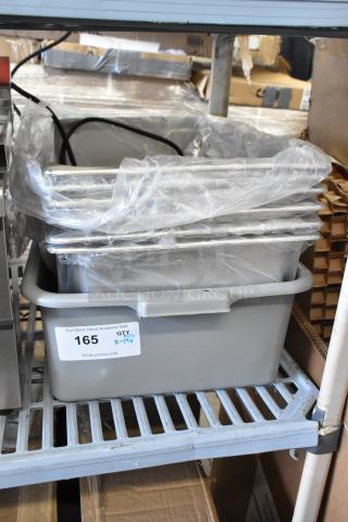 14 new scratch and dent items including Vollrath pan, Choice bus tub, and steam table pan on shelf. Item label: 165.
