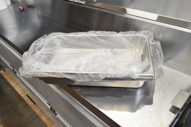 14 brand new scratch and dent items, including Vollrath stainless steel deli pan. Wrapped in plastic, showroom condition.