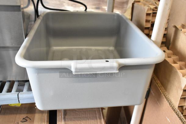 Gray polypropylene bus tub, 20" x 15" x 5", new condition, seen on a shelf among boxed items. Ideal for food storage.
