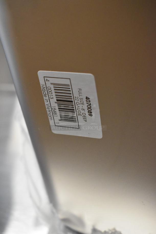 Label on a steel pan reads "4070089 Full Size 8" Deep 22 Gauge Made in Vietnam," indicating depth and material thickness.