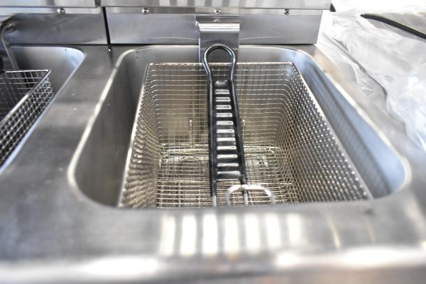 Avantco 177F202 dual tank fryer, 30 lb capacity, with two metal baskets and lids. Scratch and dent condition.