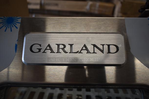 Brand new Garland/US Range 4520312 Mco Door Rt Window Kit. Features stainless steel with minor scratches. Logo visible.