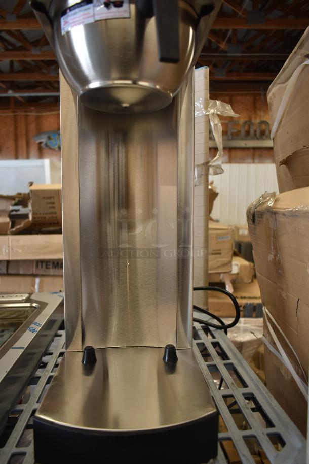Brand new Avantco 177C15 pourover airpot coffee brewer, stainless steel, 120V, showing minor scratches and dents.