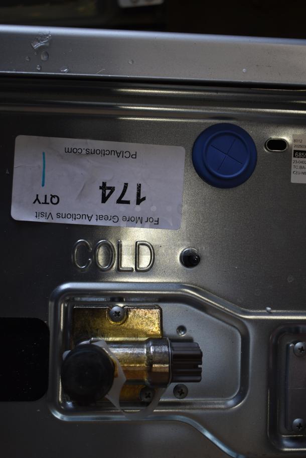 Alt Text: Rinnai RX199iN wall-mounted tankless water heater with "COLD" label, blue cap, and auction sticker visible.