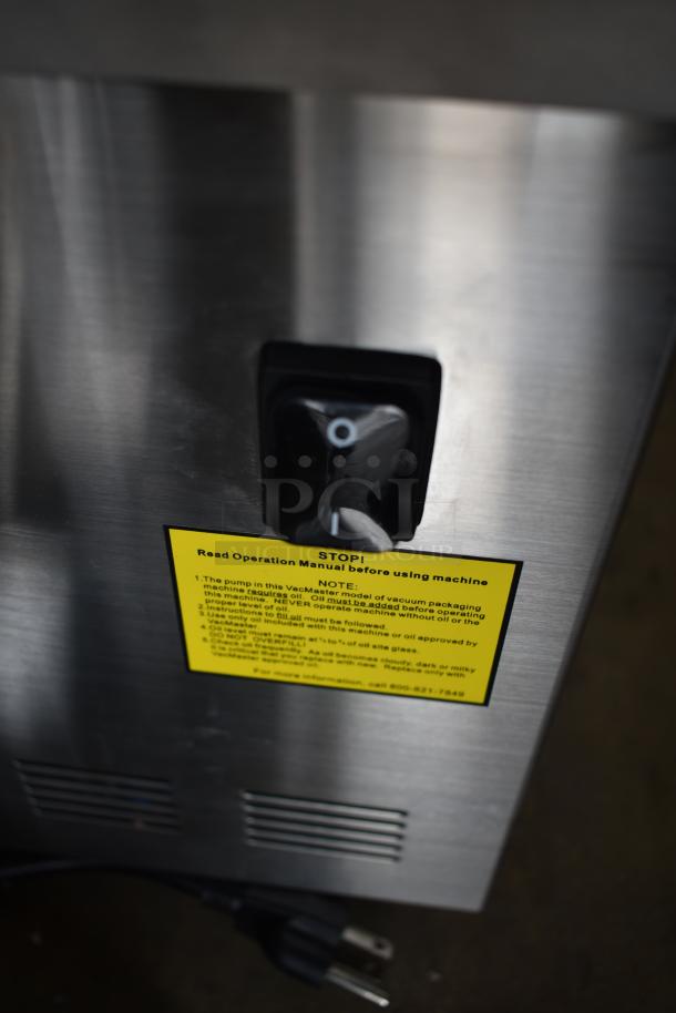 VacMaster VP230 Chamber Vacuum Packaging Machine, stainless steel, 12 1/4" seal bar. Label instructs reading manual before use.