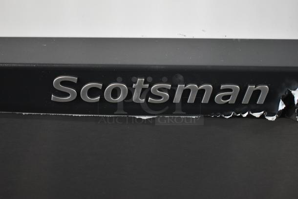 Brand new, scratched Scotsman HID525AB-1A countertop ice machine and water dispenser with damaged exterior surface.