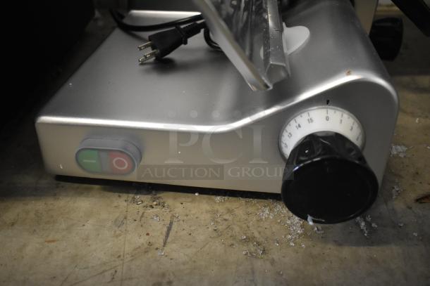 Brand new Avantco 177SL312 12" manual meat slicer, 115V, with minor scratches. Features feed tray and control knobs.