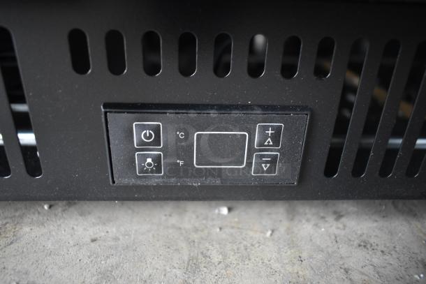 Summit SCR610BL glass door beverage refrigerator control panel, showing power and temperature buttons. Stainless steel build.