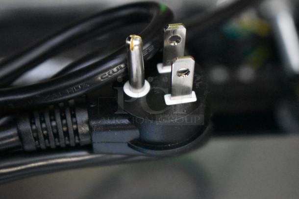 Close-up of a Summit SCR610BL refrigerator plug. The cord is black, three-pronged, and in new condition.