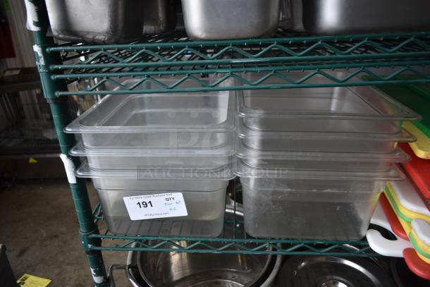 Two-tier lot with cutting boards, clear plastic bins, and stainless steel cylindrical bins. Auction tag 191 visible.
