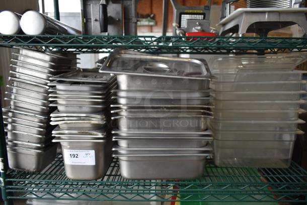 Auction lot of stainless steel and poly drop-in bins on a shelf, various sizes, used condition. Label indicates Tier Lot 192.