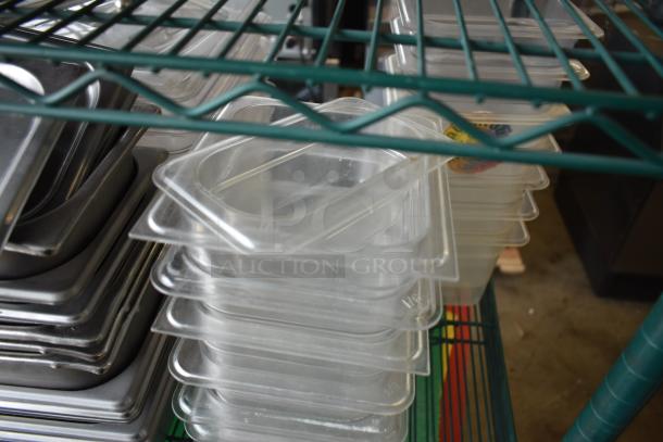 Pair of stacks of stainless steel and poly drop-in bins on a metal shelf, in used condition.