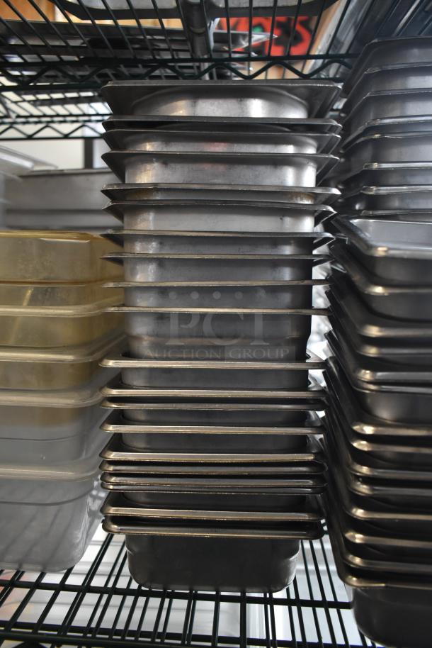 Tiered stack of stainless steel and poly drop-in bins, varying sizes. Used kitchenware, ideal for catering or restaurant use.