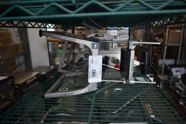 Lettuce head cutter and vegetable cutter, metal frame, black handles, displayed on a shelf with auction tag 193.