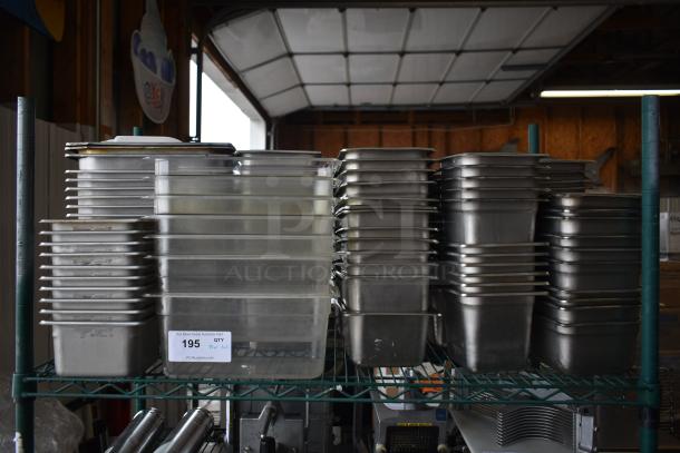 Tiered lot of stainless steel and poly drop-in bins on a metal shelf. Includes auction tag with lot number 195.