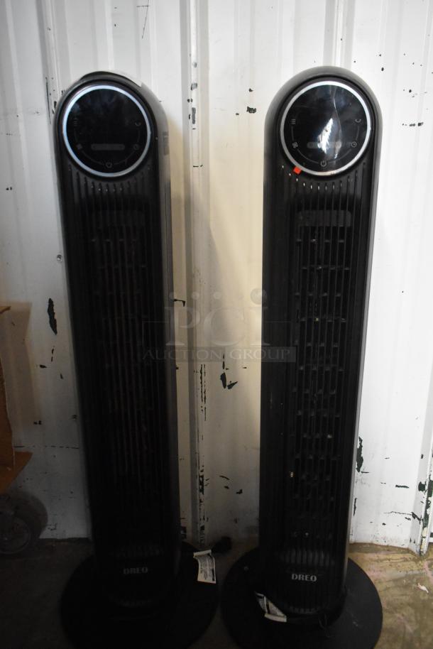 Two Dreo DR-HTFOOT tower fans, black, 120 volts, 1 phase, with control panels, in functional condition.