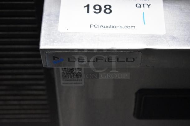 Delfield commercial single door undercounter cooler with label. 115 volts, 1 phase, on casters. Note: small surface scratches.