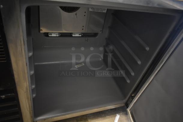 Delfield single door undercounter cooler, 115 volts, 1 phase, on commercial casters, shown open with shelves inside.