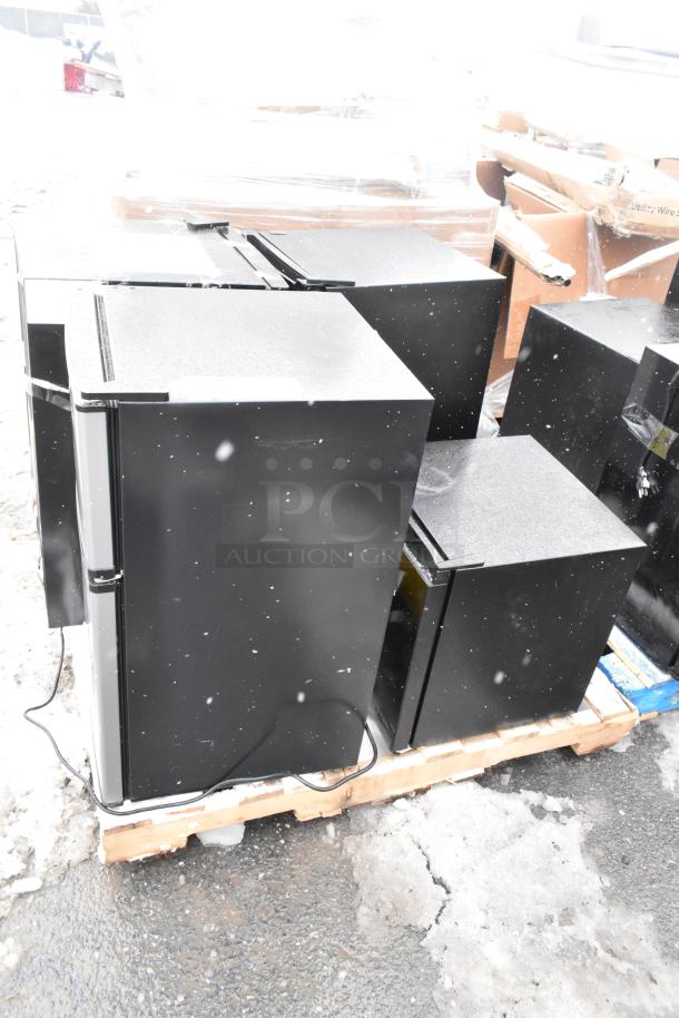Four mini coolers on pallet, including Arctic King ARM32D5ABB and Galanz GLR33MBKE23, 120V, 1 Phase. Snow-covered.