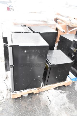 Four mini coolers on pallet, including Arctic King ARM32D5ABB and Galanz GLR33MBKE23, 120V, 1 Phase. Snow-covered.