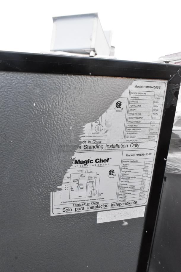 Magic Chef HMDR450SE mini cooler, shows manufacturer label with specs: 115 VAC, 1.37 oz R600a refrigerant, 120 volts.