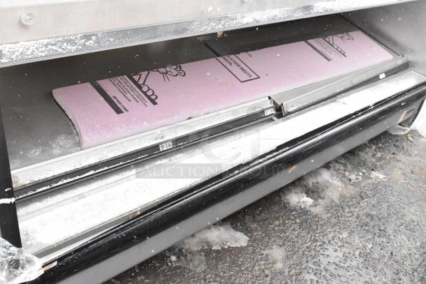 Commercial floor style open merchandiser with stainless steel frame, shelf spaces, and insulation panels, used condition.