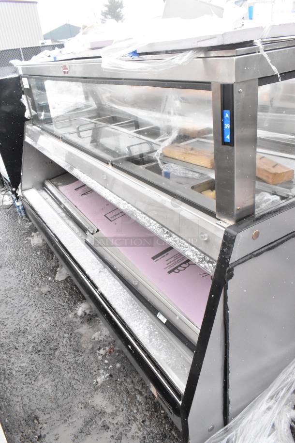 Commercial floor style open merchandiser with glass front and stainless steel frame, good condition, visible shelving units.