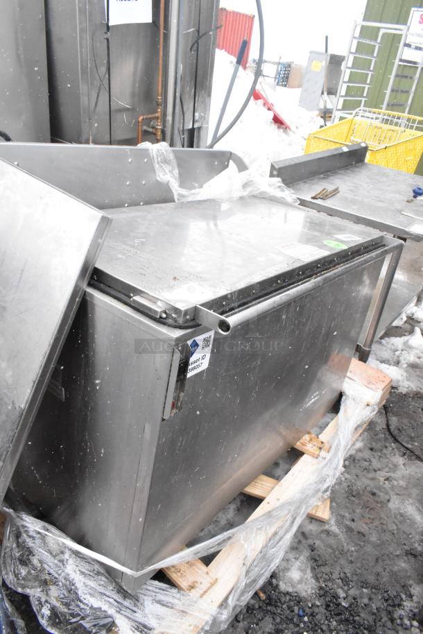 Commercial floor style washing tank, stainless steel, used condition with visible signs of wear, asset ID tag present.