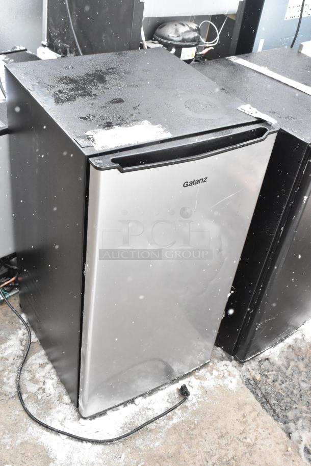 Two mini coolers, Galanz GLR33MS1E02 and Kismile BD-88B-E, 120V, 1 phase. Metal finish, slight surface wear.