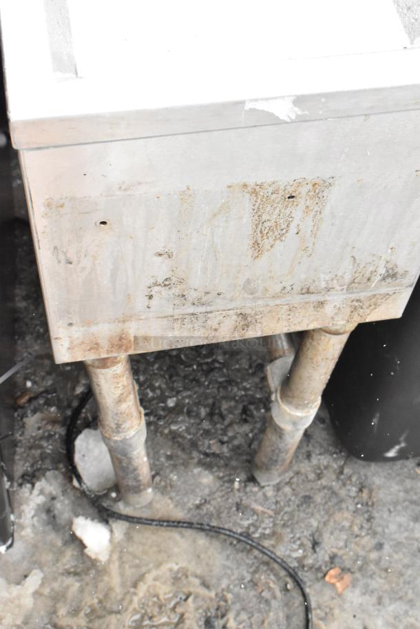 Stainless steel BK Resources BKUBD-12-21S Drain Board, visible rust and wear, dual pipe supports, industrial setting.