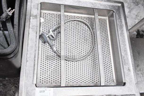 Stainless steel bin with perforated straining insert, coiled hose. Mounted on commercial casters. Auction tag: "209".