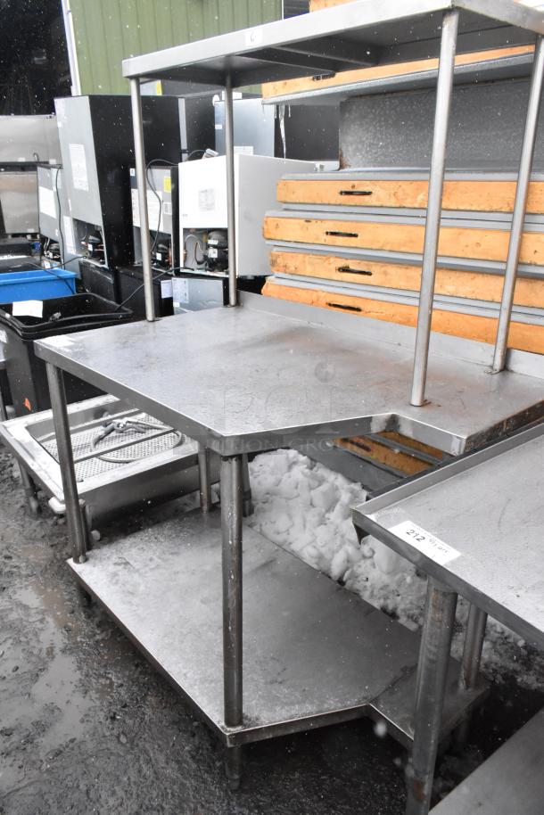 Stainless steel table with under shelf and over shelf, industrial design. Durable, suitable for kitchen or commercial use.