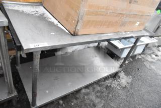 Stainless steel table with under shelf, used condition, small surface scratches. Label marked "212" visible.