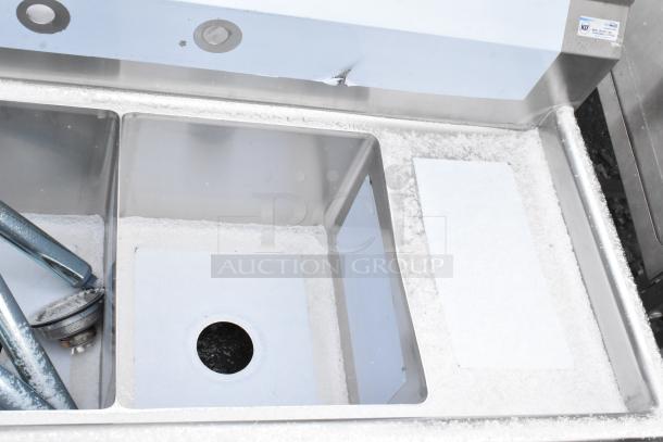 Brand new KoolMore 2 Bay Sink with dual drain boards, visible scratches and dents, NSF label, stainless steel finish.