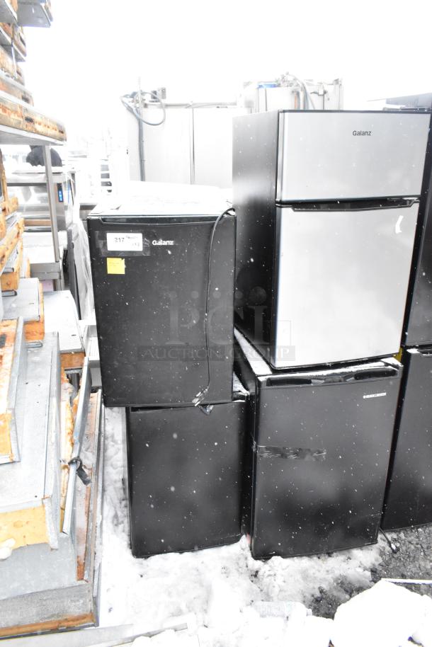 Eight mini coolers including Galanz GLR33MBKE23, EdgeStar CMF151L, Mainstays DG40BY1A. Black and silver, varied condition.
