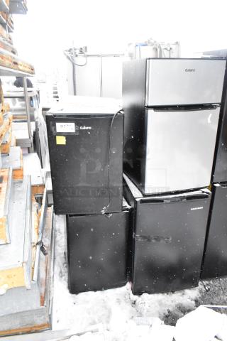 Eight mini coolers including Galanz GLR33MBKE23, EdgeStar CMF151L, Mainstays DG40BY1A. Black and silver, varied condition.