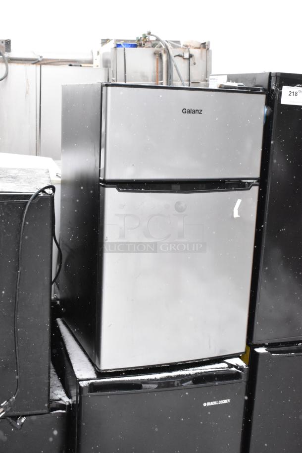 Stack of 8 mini coolers including Galanz GLR33MBKE23, 120V, 1-phase. Visible brands include Galanz and Black+Decker.