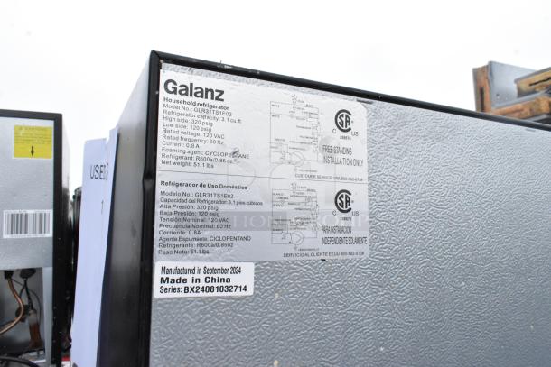 9 mini coolers, including Galanz GLR33MBKE23 and GLR31TS1E02, 120V, 1-phase. Labels show specs: 3.1 cu ft, R600a refrigerant.