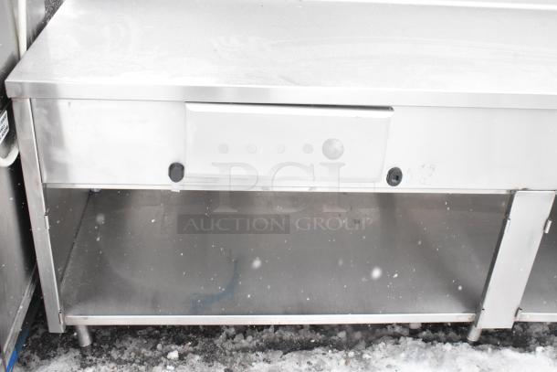 Win-holt stainless steel table with two drawers and undershelf. Features sturdy construction, suitable for commercial use.