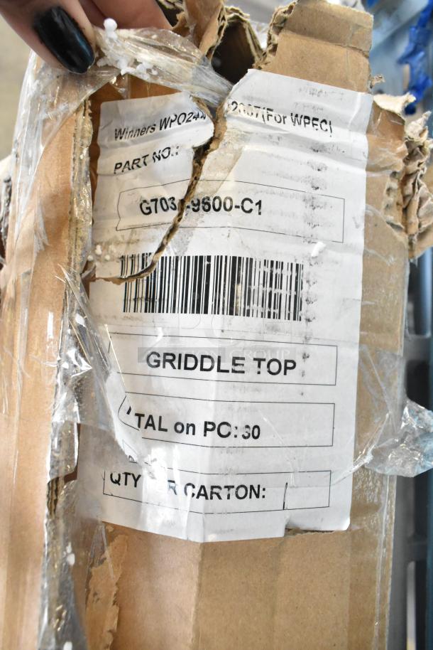 New G703-9600-C1 Griddle Top in damaged packaging. Visible label indicates model and part numbers.
