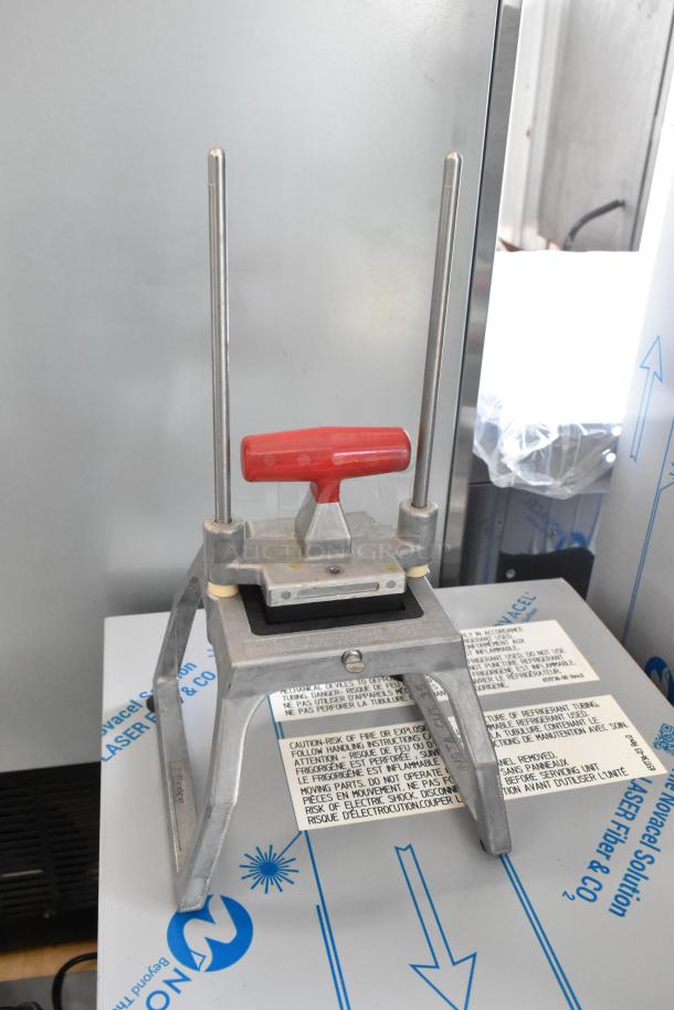 Lettuce head cutter with red handle, metal frame, and caution labels, suitable for efficient vegetable prep.