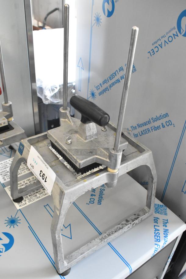 Stainless steel lettuce head cutter in good condition, features dual handles and marked NSF certification tag, lot number 193.