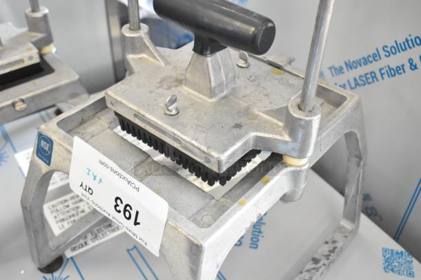 Heavy-duty lettuce head cutter, metal build, ergonomic handle, NSF certified, auction label indicating lot 193, good condition.